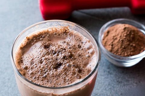 Glass of coffee mixed with protein powder - a proffee